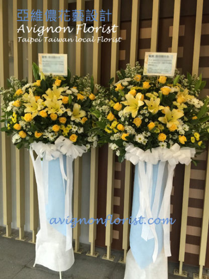 A funeral arrangement of yellow roses