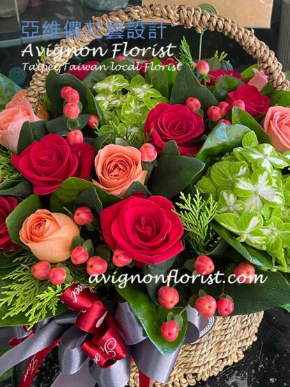 Red roses and green hydrangea in a basket