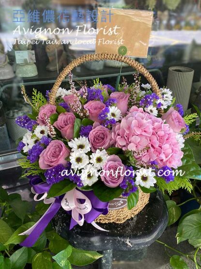 Basket of purple roses and hydrangea