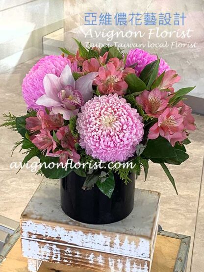 Lighter pink chrysanthemums and orchids.