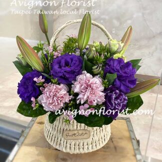 A basket of Lilies, carnations, and lisianthus