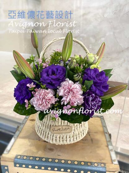 A basket of Lilies, carnations, and lisianthus