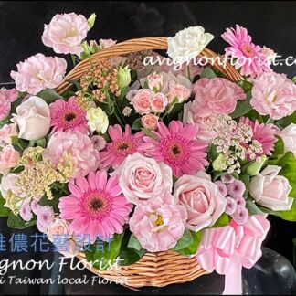 Natural flower basket featuring mixed blooms in soft pastel tones, styled with an open, garden-inspired arrangement.