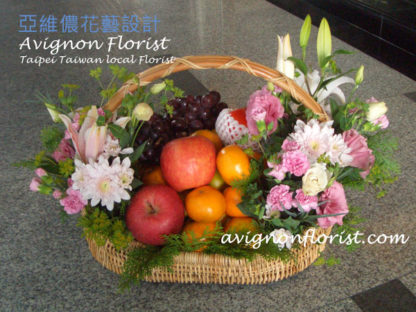 Basket of fruit and lilies