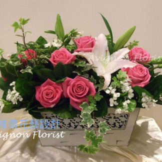 A basket of pink roses and lilies