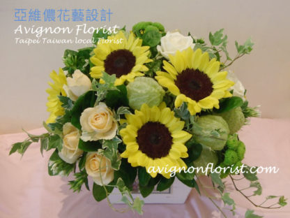 Sunflowers and roses in a box