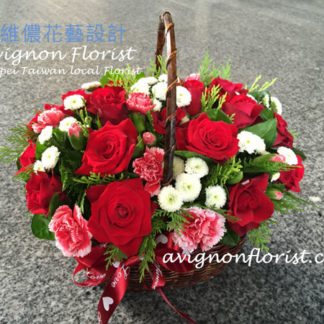 Basket of red roses and other flowers