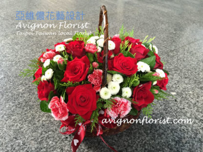 Basket of red roses and other flowers